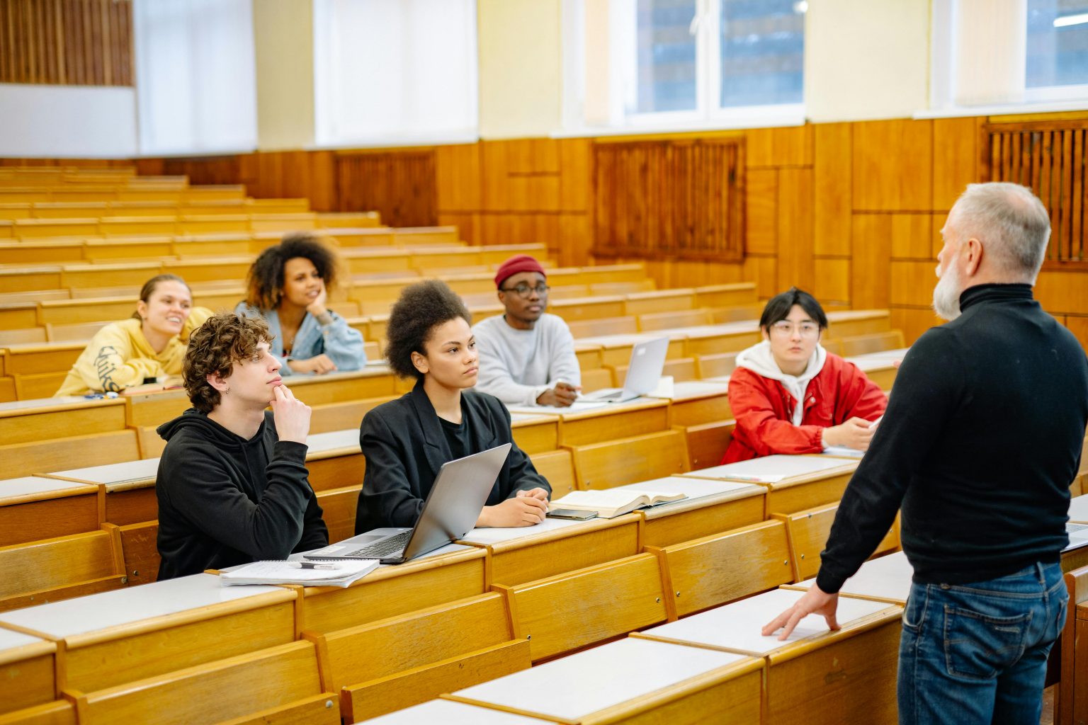 University students engaging in a diverse classroom setting with a lecturer.